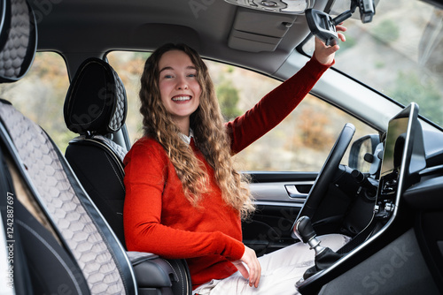 Tableau sur toile A female driver following safe ride rules, looking at the camera and smiling