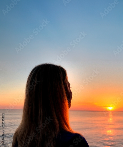 a woman watching a sunset on a torpical beach generated with artificial intelligence photo