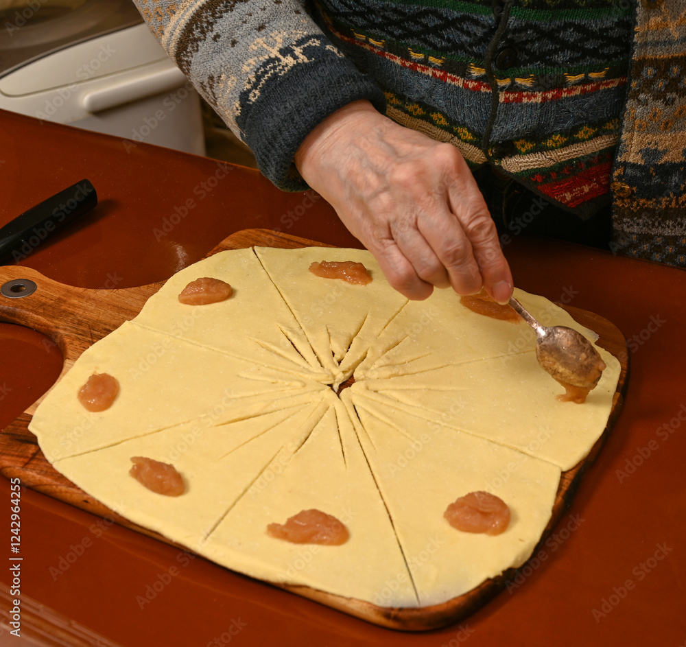 Baking tradition with dough and fruit filling in a cozy kitchen setting during winter