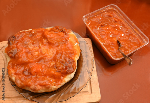 Obraz na płótnie A delicious baked bread is presented on a glass plate, generously topped with jam w salonie