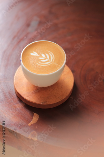 Latte Art Design Creates Beautiful Coffee on Wooden Coaster, Perfect Morning Beverage