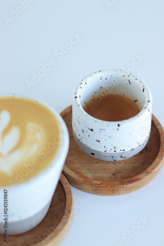 Espresso and Latte Art Coffee Drinks Served Elegantly on Wooden Coasters Beautifully