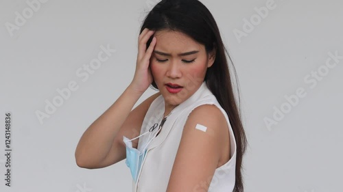 Unhealthy Asian woman getting vaccinated immunity with muscle pain, concept of inoculation, vaccination, side effects of vaccine, inoculating coronavirus antibody response with undesirable side effect