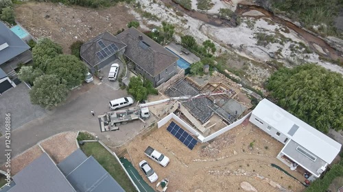 A truck delivers concrete to a building site on a river photo