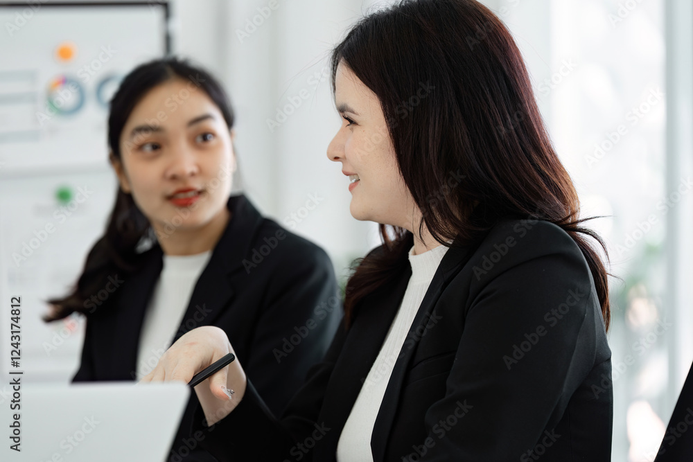 Diverse female business professionals collaborating and discussing strategies in the office. Diverse female business professionals collaborating and discussing strategies in the office.