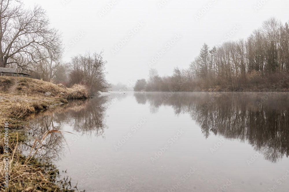 Foggy Riverbank with Still Water Reflection – Tranquil Winter Landscape Foggy Riverbank with Still Water Reflection – Tranquil Winter Landscape