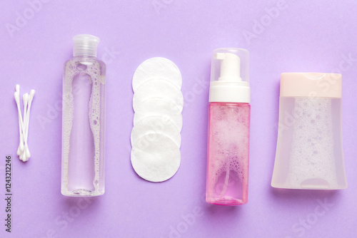 Micellar cleansing water and discs to remove cosmetics and cleanse the skin on colored background. Copy space top view photo