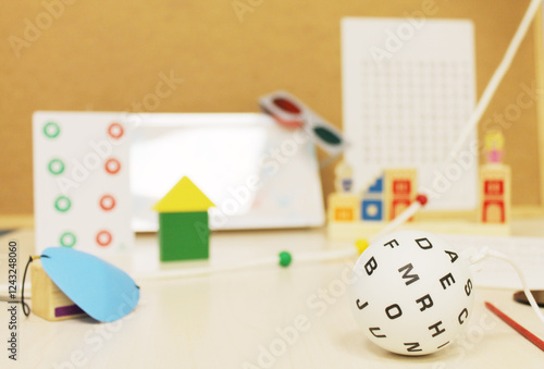 Different objects to do visual therapy with children, ball with letters, red-green glasses and games.