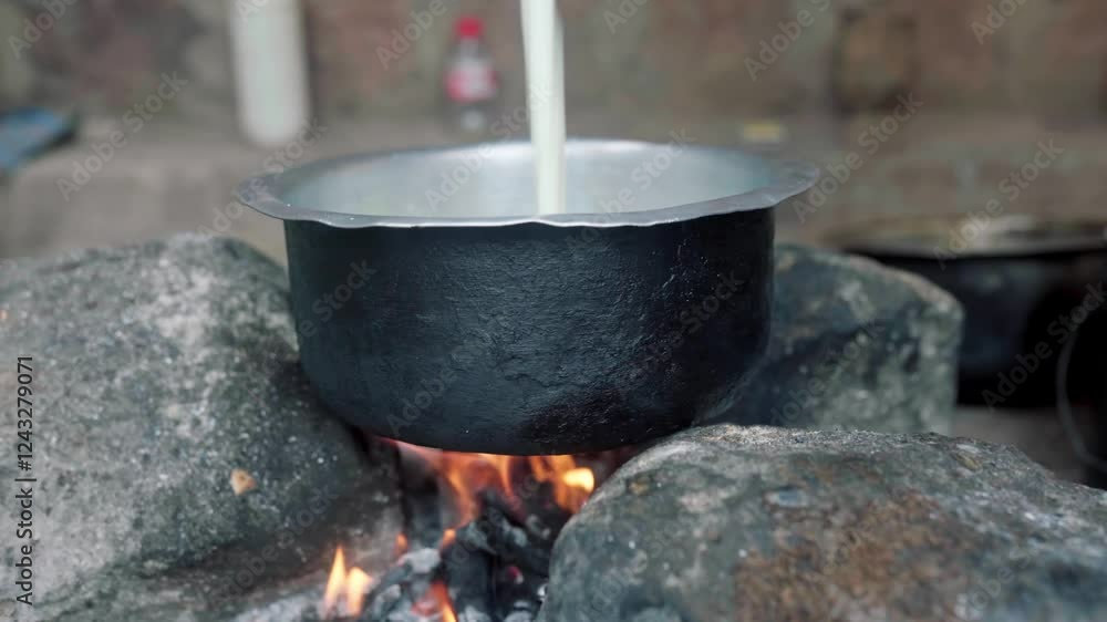 African woman boiling milk in a fire African woman boiling milk in a fire