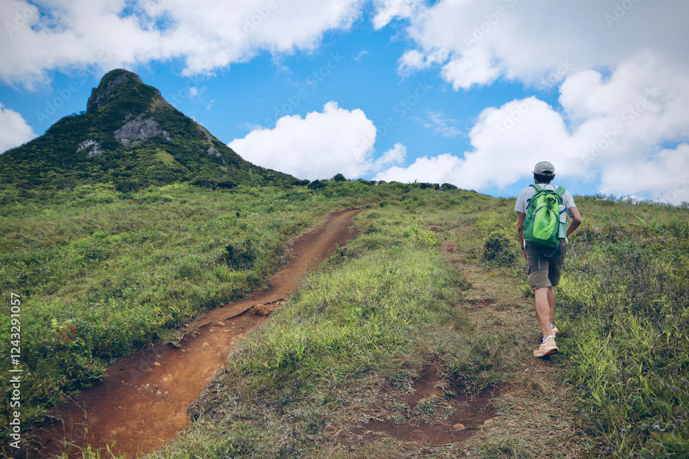 Fototapeta premium Man is hiking in mountains. Travel adventure during vacation, outdoor healthy lifestyle and eco tourism