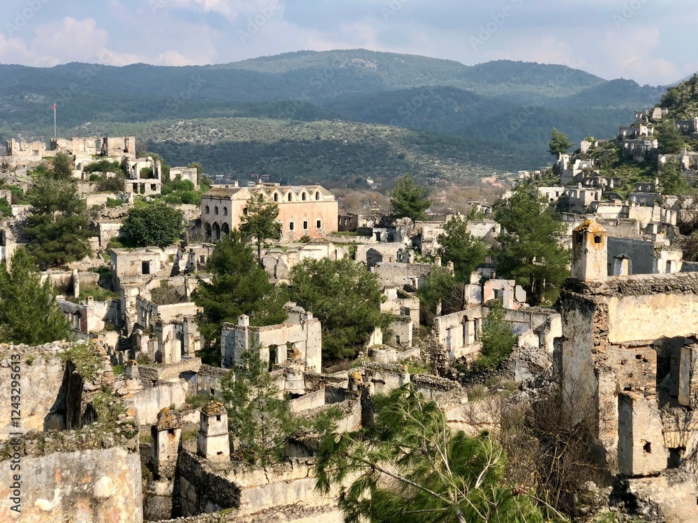An abandoned ghost village in the hills of Turkey surrounded by mountains and trees An abandoned ghost village in the hills of Turkey surrounded by mountains and trees