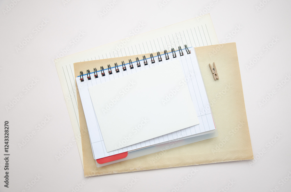 Office workspace with notebook, paper, small wooden clip. Flat lay, top view, business, work, mockup concept. copy space. Checklist, plan template. Office workspace with notebook, paper, small wooden clip. Flat lay, top view, business, work, mockup concept. copy space. Checklist, plan template.