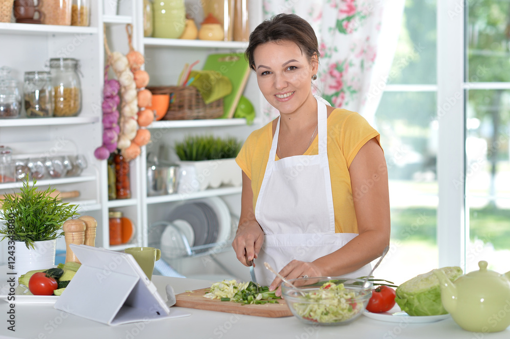 Beautiful happy woman coocking salad on kitchen Beautiful happy woman coocking salad on kitchen