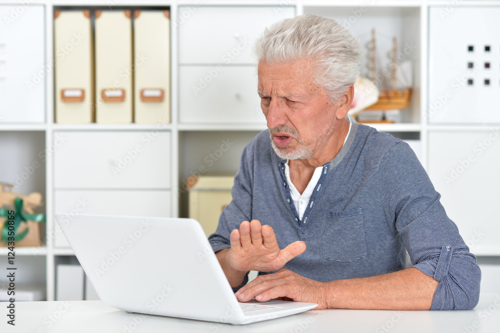 Portrait of senior man with laptop at home Portrait of senior man with laptop at home