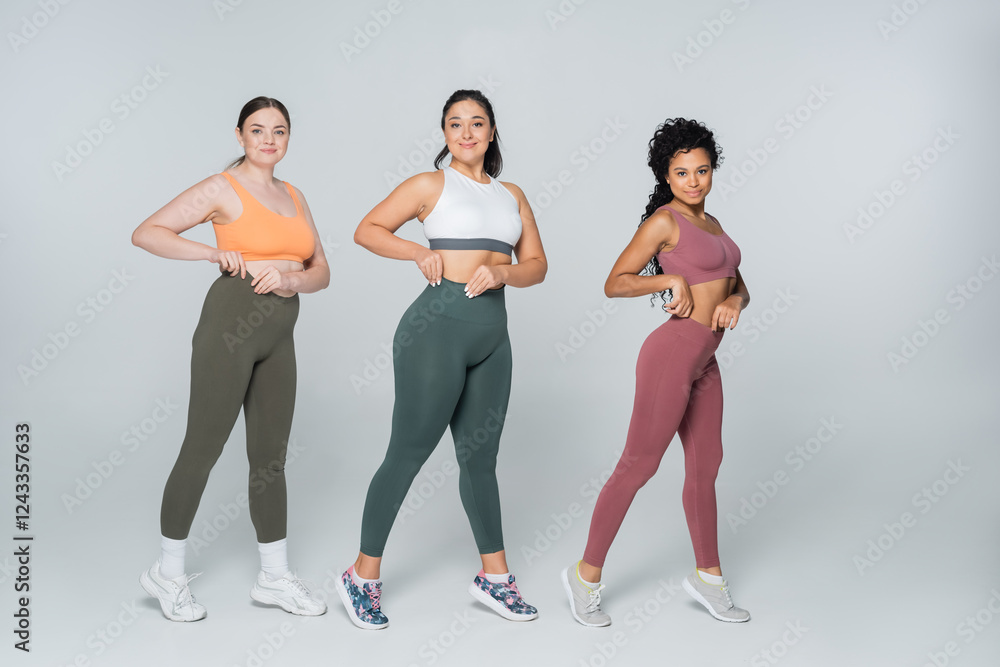 Obraz premium Embracing strength and beauty in fitness with a powerful trio of women