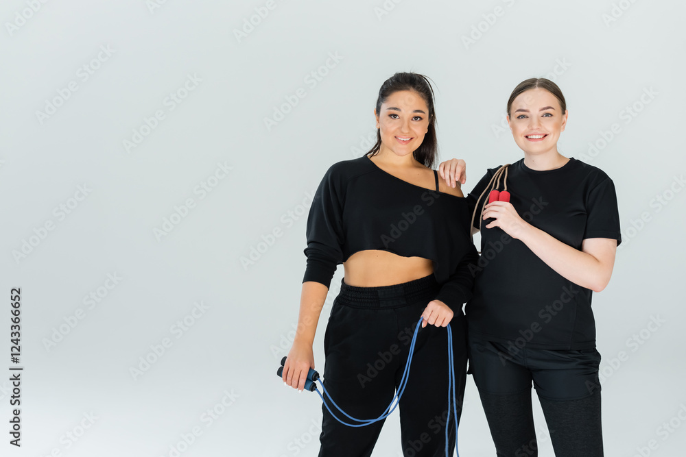 © LIGHTFIELD STUDIOS - Empowering women in fitness during a vibrant workout session in a modern studio