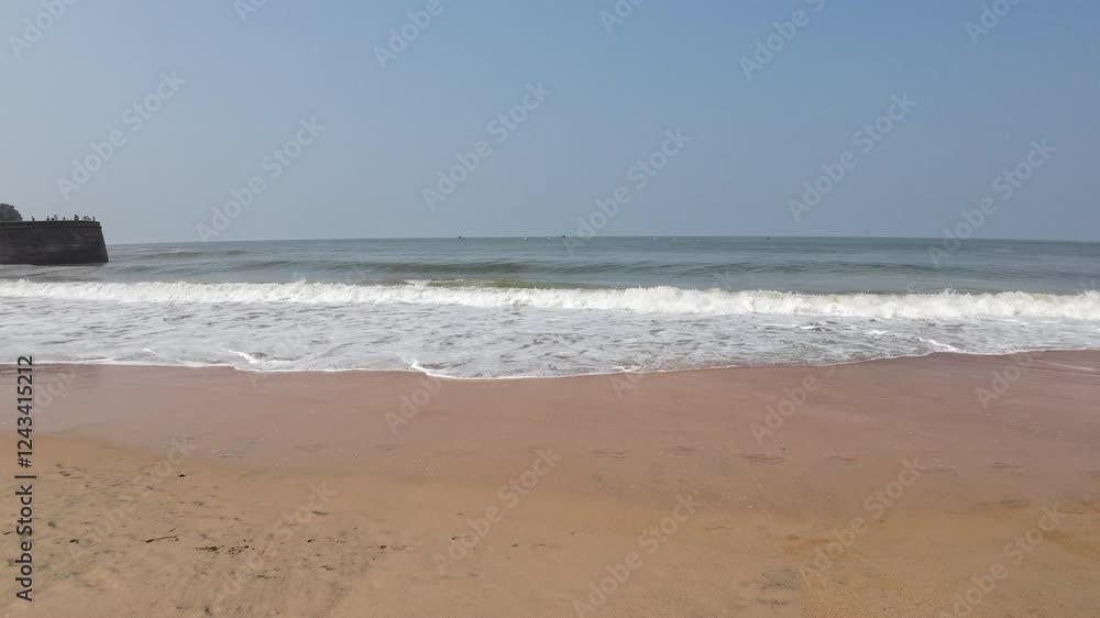 Yellow Sandy Beach With Rolling Waves And Sea Shore With Blue Sky Yellow Sandy Beach With Rolling Waves And Sea Shore With Blue Sky