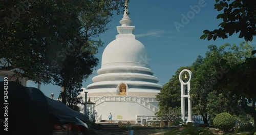 Japanese Peace Temple In Rumassala, Galle, Sri Lanka. Famous landmark and cultural sacred place. The golden statue of Lord Buddha in Parinirvana, Japanese Peace Pagoda. photo