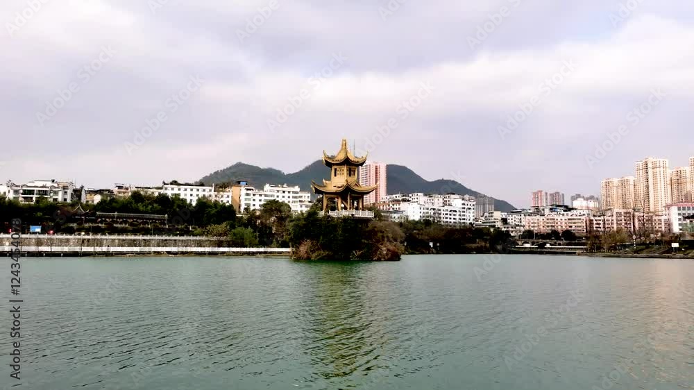 4k aerial video capturing a serene lakeside view with traditional architecture and picturesque mountains at midday 4k aerial video capturing a serene lakeside view with traditional architecture and picturesque mountains at midday