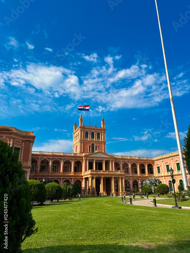 Vászonkép Palace in Paraguay with flag flying and blue sky
