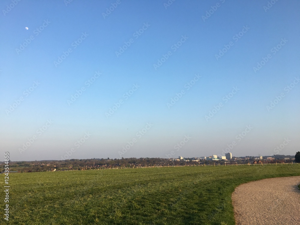 A beautiful green landscape with a city in the horizon A beautiful green landscape with a city in the horizon