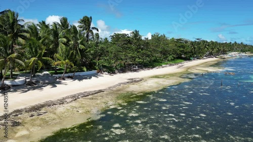 General Luna, Siargao, Philippines, showcasing a tropical coastline with palm trees, crystal-clear waters, and a vibrant seaside community.