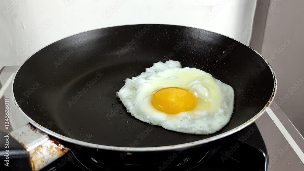The process of cooking fried eggs directly in the frying pan The process of cooking fried eggs directly in the frying pan