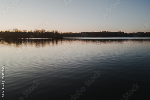 Stimmungsvolle Naturmomente am Breitenauer See bei Sonnenuntergang photo