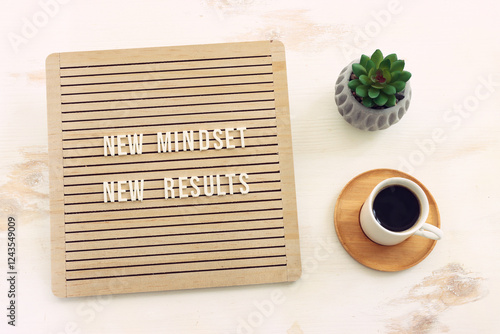 top view image of table with wooden board and the text new mindset. success and personal development concept photo