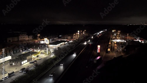 Wallpaper Mural Aerial night drone footage of a highway with illuminated gas station. Dynamic lights, moving traffic, and roadside infrastructure create a cinematic scene. Ideal for travel, logistics, or night city v Torontodigital.ca