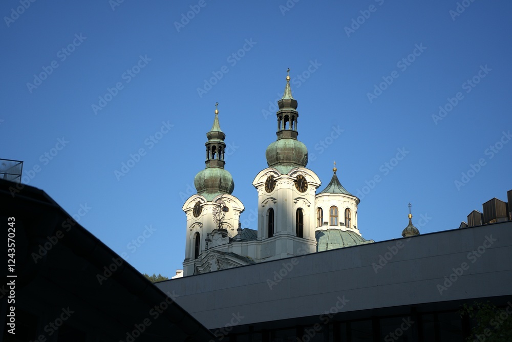 Obraz premium Church towers silhouette. Green domes architecture. Deep blue sky. Historic religious landmark. 