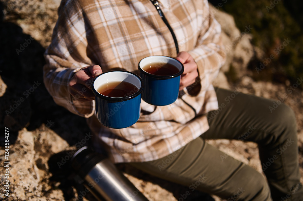 Person Outdoors Holding Two Cups of Tea Amid Scenic Nature Background Person Outdoors Holding Two Cups of Tea Amid Scenic Nature Background