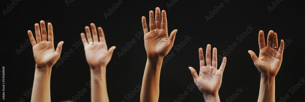 A vibrant scene with many hands raised high, showcasing strong engagement and participation at a conference set against a dark backdrop, symbolizing enthusiasm and community involvement A vibrant scene with many hands raised high, showcasing strong engagement and participation at a conference set against a dark backdrop, symbolizing enthusiasm and community involvement