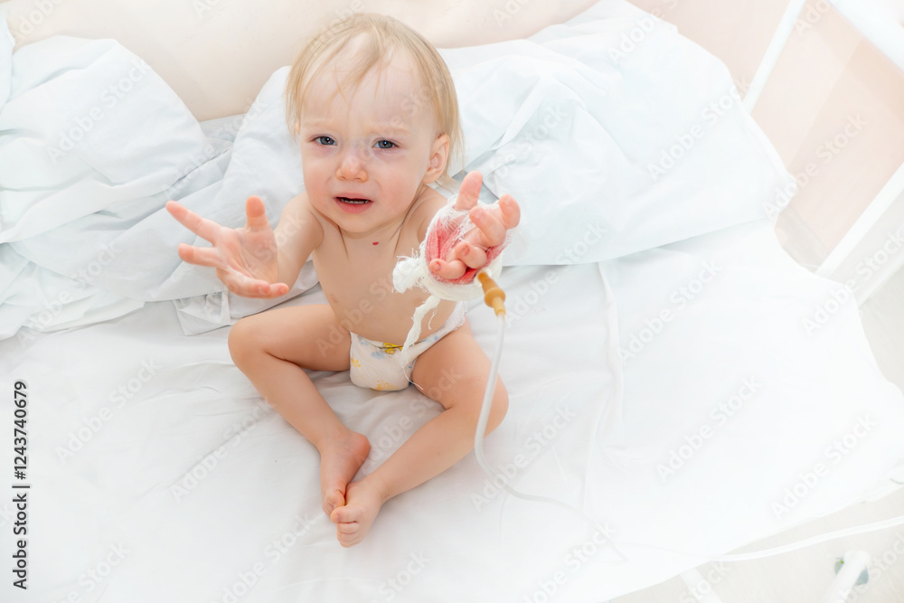 Children illness . Little Baby attaching intravenous tube to patient's hand in hospital bed. Baby sick and crying and baby want mom