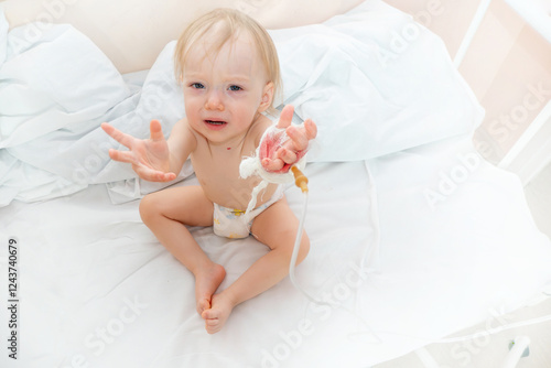 Obraz na płótnie Children illness . Little Baby attaching intravenous tube to patient's hand in hospital bed. Baby sick and crying and baby want mom w salonie