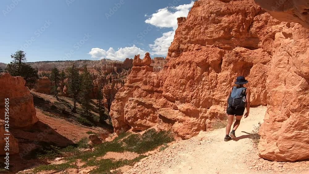 A hiker ventures into Bryce Canyon's mesmerizing rock passageways and sunlit trails. A hiker ventures into Bryce Canyon's mesmerizing rock passageways and sunlit trails.