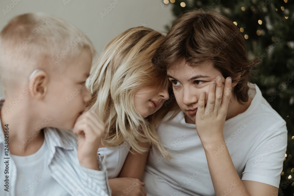 A loving mother with her son and daughter enjoys the magical atmosphere of Christmas and New Year. The family shares joyful moments, playing together, laughing, and creating warm holiday memories A loving mother with her son and daughter enjoys the magical atmosphere of Christmas and New Year. The family shares joyful moments, playing together, laughing, and creating warm holiday memories