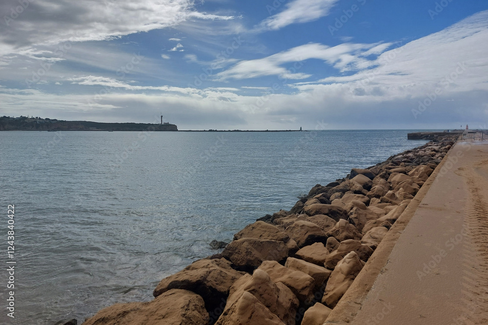 Serene Seaside Landscape with Lighthouse and Cloudy Sky Serene Seaside Landscape with Lighthouse and Cloudy Sky