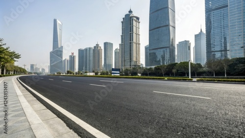 Wide asphalt road stretching through a modern cityscape with sleek skyscrapers and glass towers in the background, urban development, urban architecture