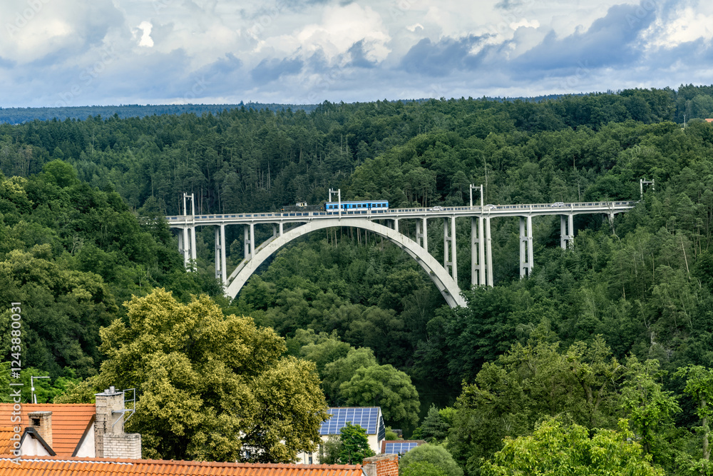 Railway and road arched bridge over a deep valley between two hills in the town of Bechyně. Bridge over the Lužnice River, Czech Republic.