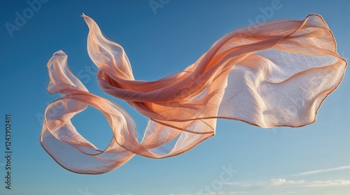 Peach-colored fabric dances in the wind against a vibrant blue sky. Light and airy, it evokes a sense of freedom and serenity.