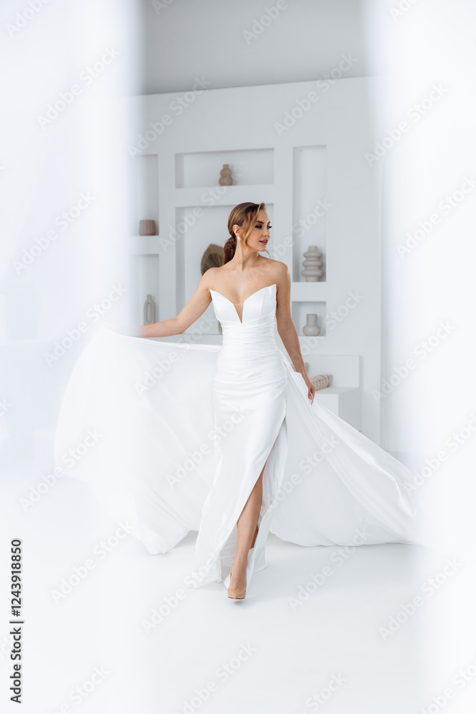 Bride in a dress with a train that flutters around on a white background. Stylish trendy wedding 2025 Bride in a dress with a train that flutters around on a white background. Stylish trendy wedding 2025