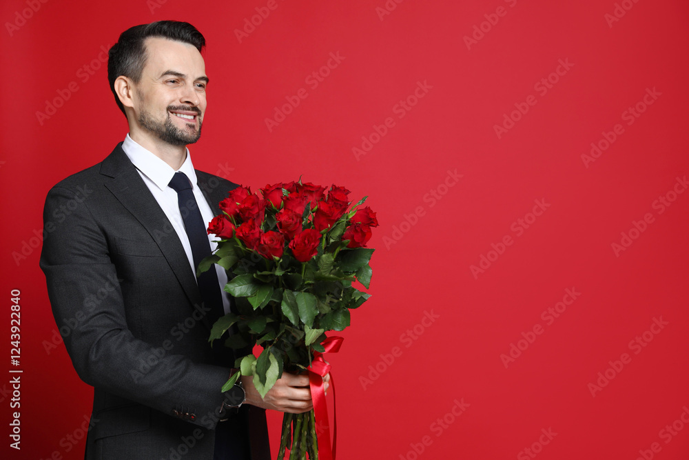 Happy Valentine's Day. Handsome man with bouquet of roses on red background. Space for text Happy Valentine's Day. Handsome man with bouquet of roses on red background. Space for text