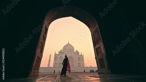 A woman in an Indian sari dancing in slow motion at the Taj Mahal, India