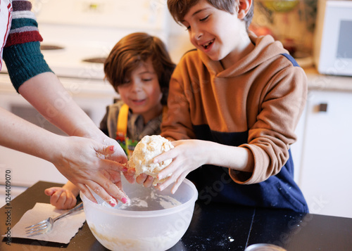Children having fun and helping prepare food in the kitchen