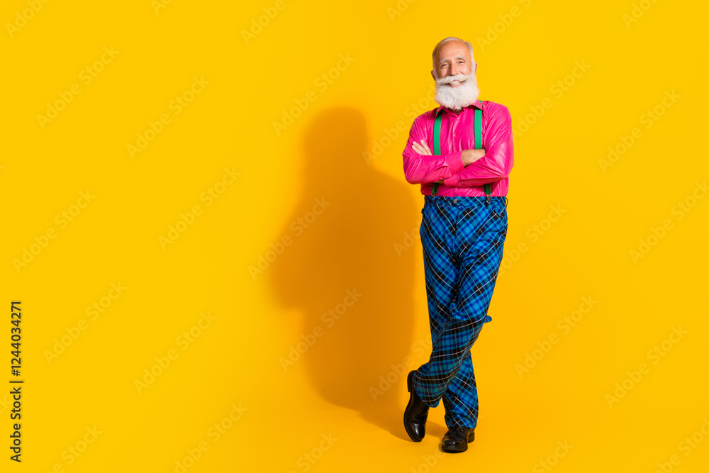 Fototapeta premium Full length photo of nice senior male crossed hands wear pink shirt plaid pants suspenders fancy outfit isolated on yellow color background