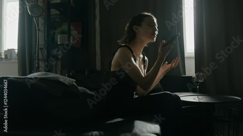 Caucasian young woman dialling number, hysterically shouting into her gadget having emotional call, then impulsively throwing phone on couch and crying