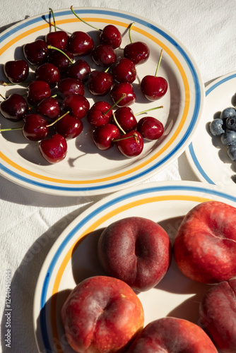 Cherries, Peaches, and Blueberries on Striped Plates photo