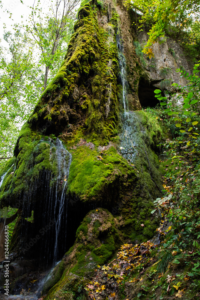 Beautiful waterfall in the forest, beautiful nature with a waterfall, a waterfall with blue water drowning in greenery, Maliyevsky waterfall, moss on stones, water flow from a waterfall, tourism, wate Beautiful waterfall in the forest, beautiful nature with a waterfall, a waterfall with blue water drowning in greenery, Maliyevsky waterfall, moss on stones, water flow from a waterfall, tourism, wate