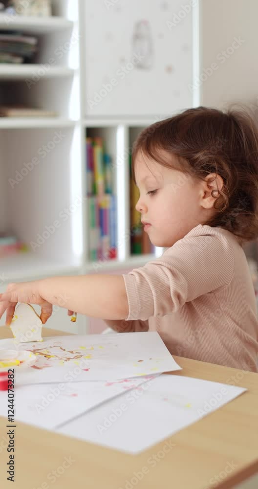 cute little child girl painting hen-shaped gypsum figure in yellow. creativity. Handmade toy cute little child girl painting hen-shaped gypsum figure in yellow. creativity. Handmade toy